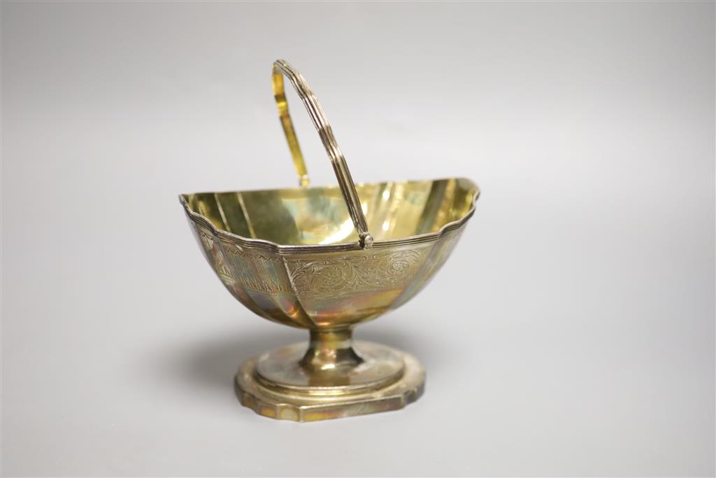 A George III silver gilt swing-handled sugar basket by Henry Chawner, 8.9oz